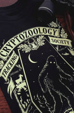 Load image into Gallery viewer, Glow in the Dark Cryptozoology Tracking Society Tee
